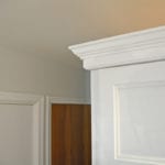white kitchen cabinet with crown molding
