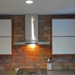 glossy white cabinet doors and stainless range hood