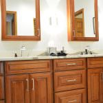 wood vanity with mirrored medicine cabinets