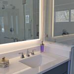 bathroom countertop and backlit mirror