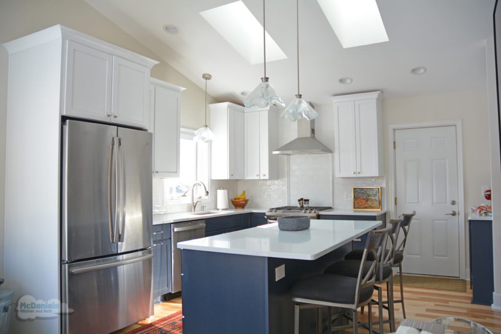 white kitchen design with blue island