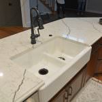 white kitchen sink and matte black faucet