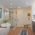 spa style bath design with freestanding tub, glass enclosed shower, and large vanity cabinet