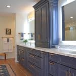 large blue vanity cabinet with center tower cabinet