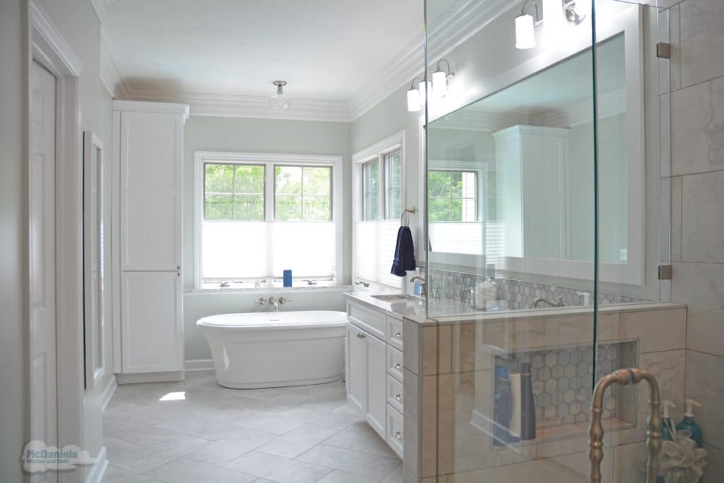 bath design with large window and vanity lights