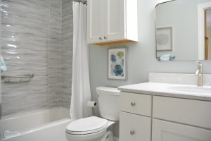 compact bath design with white vanity and alcove shower
